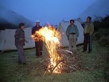 9 6 Campfire At Joksam Camp Although normally trekking groups aren�t allowed to have fires, Kumar asked Ram and Rajin to start one so we could dry out our wet clothing. The raging fire spat high into the air as we put our boots, socks and jackets near the fire. Tibetans joined us near the fire and we smiled to each other in this beautiful setting, with memories of our thefts receding from our memories. The leader of the yak herders started to sing a song, and was soon joined in by the rest of the Tibetans. We all applauded wildly as they finished. Rajin sang an Indian pop song with great feeling. Now this is what traveling is all about, I thought, meeting the local people at close distance and seeing glimpses of their lives and culture. Before long we were singing too, ending with a rousing rendition of New York, New York. The fire started to die and we all filed slowly back to our sleeping bags, happy with our multicultural performances. These happy feelings weren�t to last for very long.